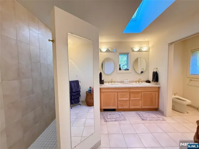 a bathroom with a granite countertop sink a mirror and a vanity