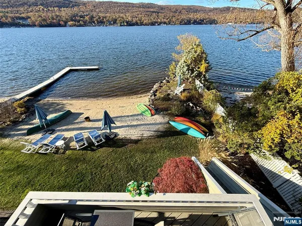 a bedroom with a bed and large window