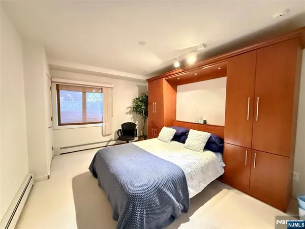 a room with furniture pool table wooden floor and windows