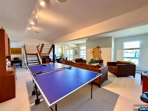 a living room with furniture a flat screen tv and a large window
