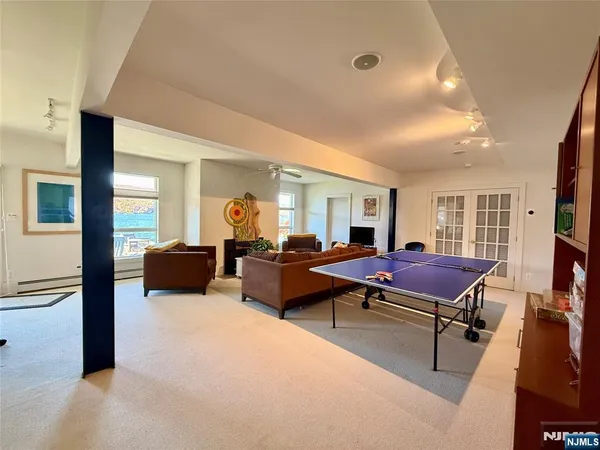 a living room with furniture a flat screen tv and a window