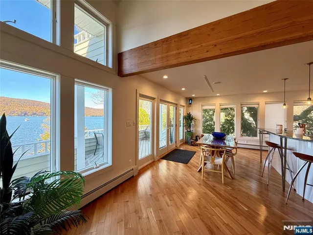 a view of a patio with table and chairs potted plants with wooden floor