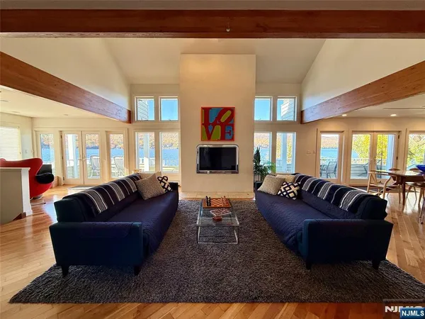 a living room with fireplace furniture and a flat screen tv
