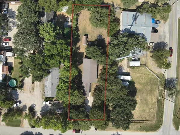 an aerial view of a house with a yard and lake view