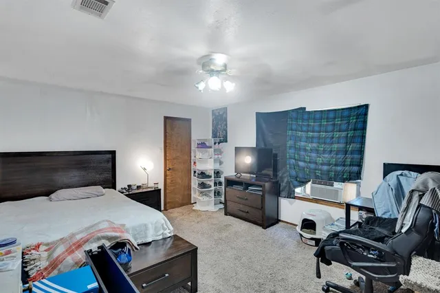 a bedroom with a bed furniture and a flat screen tv
