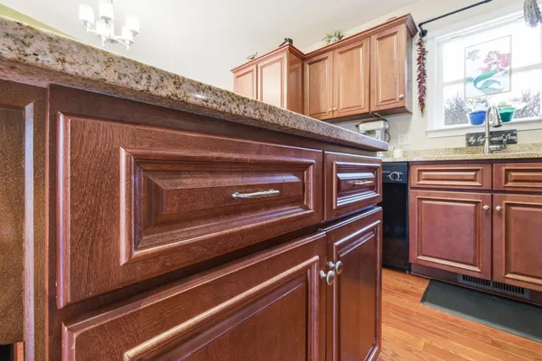 a kitchen with granite countertop a stove and a microwave