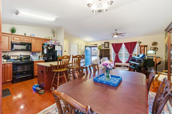 a living room with dining room and wooden floor