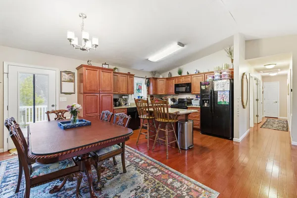 a view of a dining room with furniture and wooden floor