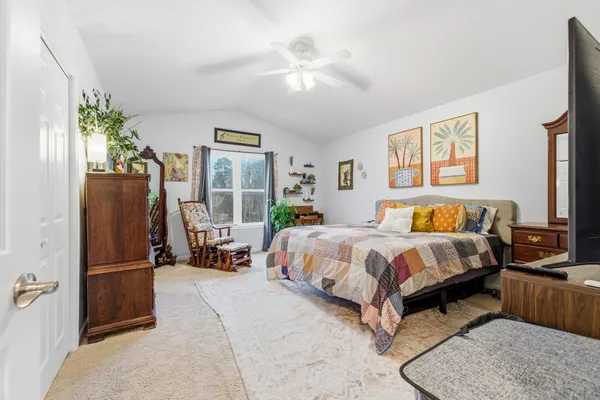 a bed room with a bed and a chandelier