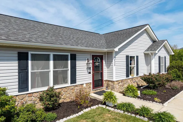 a front view of a house with garden