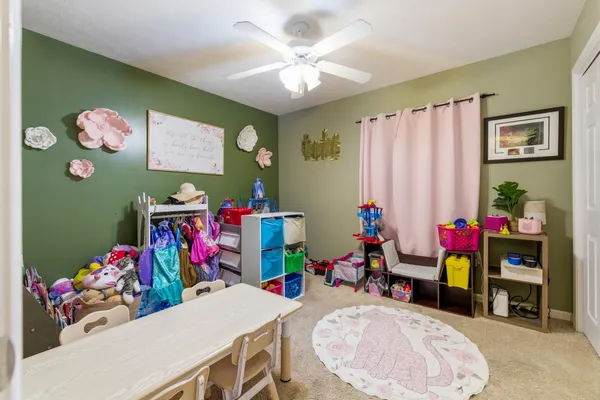 a view of a dining room with furniture and toys