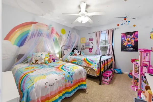 a bedroom with a bed a couch and dresser