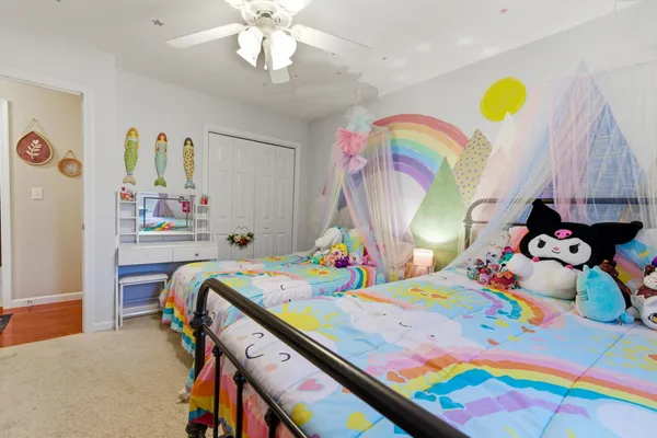 a bedroom with a bed a window and dresser