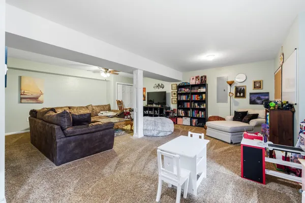 a living room with furniture and a bookshelf