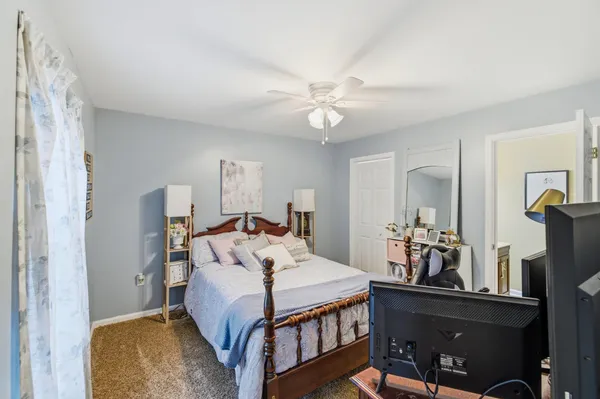 a bedroom with a bed a desk and chair