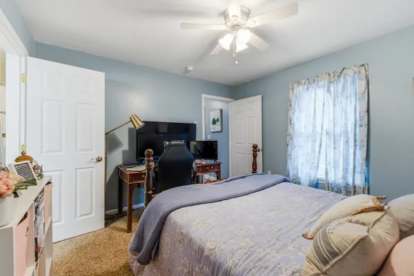 a bedroom with a bed and a chandelier