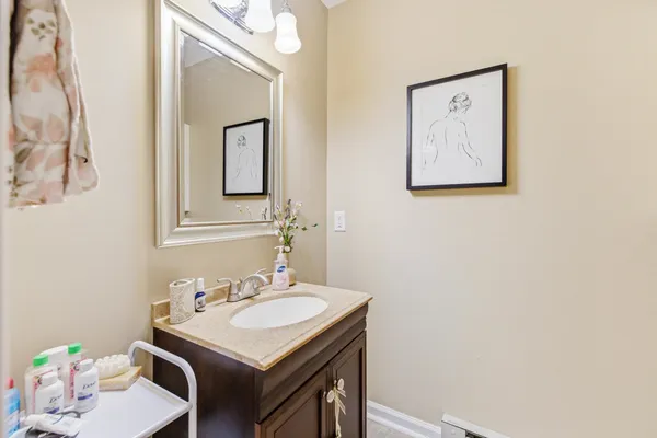 a bathroom with a sink vanity and a mirror
