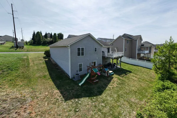 a view of a house with a backyard and a garden