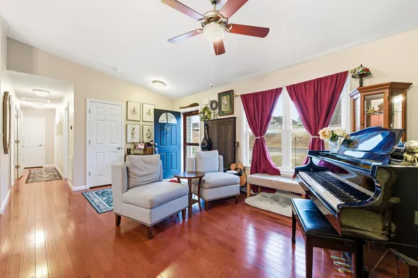 a living room with furniture and a wooden floor