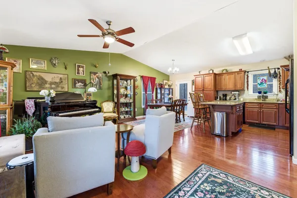 a living room with furniture and kitchen view