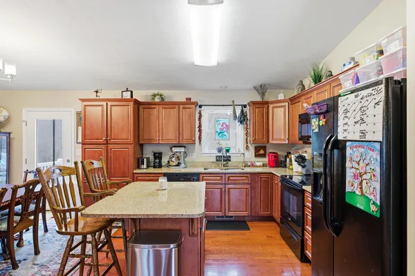 a kitchen with stainless steel appliances kitchen island granite countertop a sink and cabinets