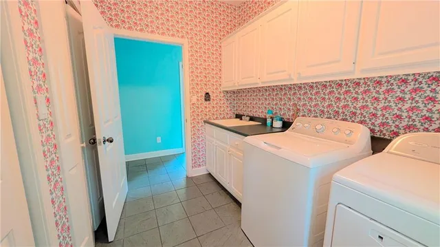 a large kitchen with stainless steel appliances a stove a sink and a refrigerator