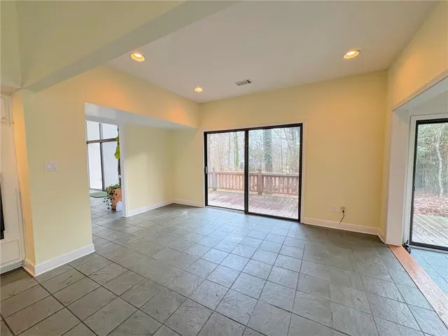 a large kitchen with granite countertop a stove a sink and a refrigerator