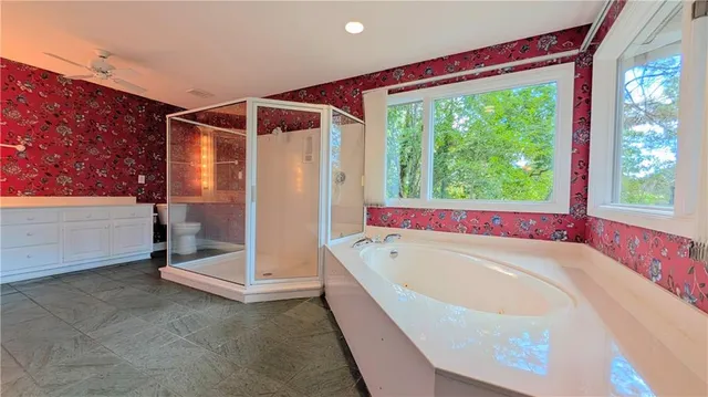 a bathroom with a bathtub and shower