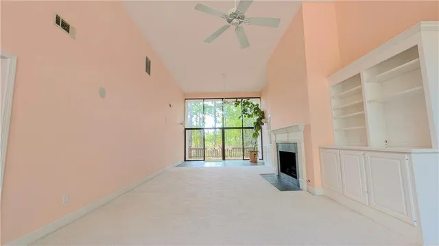 a view of a big room with windows and fireplace