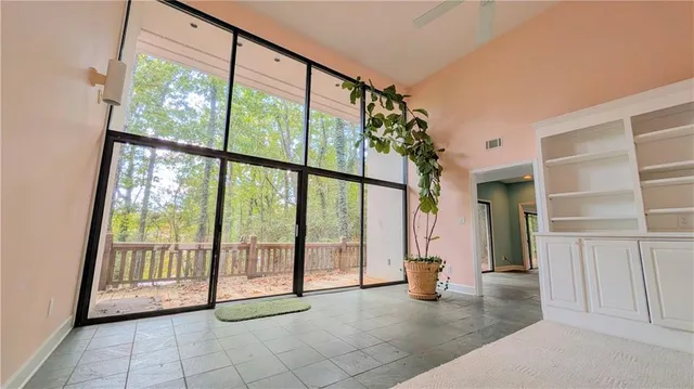 a view of an entryway with floor to ceiling windows and stairs