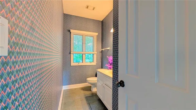 a bathroom with a toilet and a shower curtain