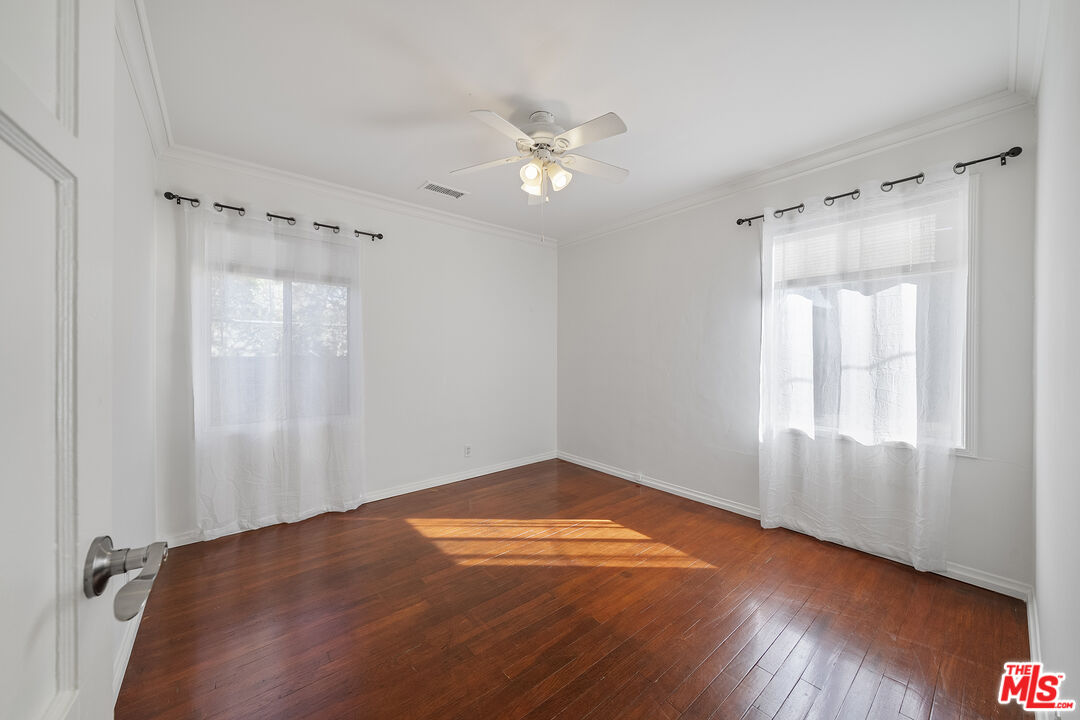 4516 Walnut Avenue Long Beach, CA 90807 - Photo 19 of 35 an empty room with wooden floor and windows