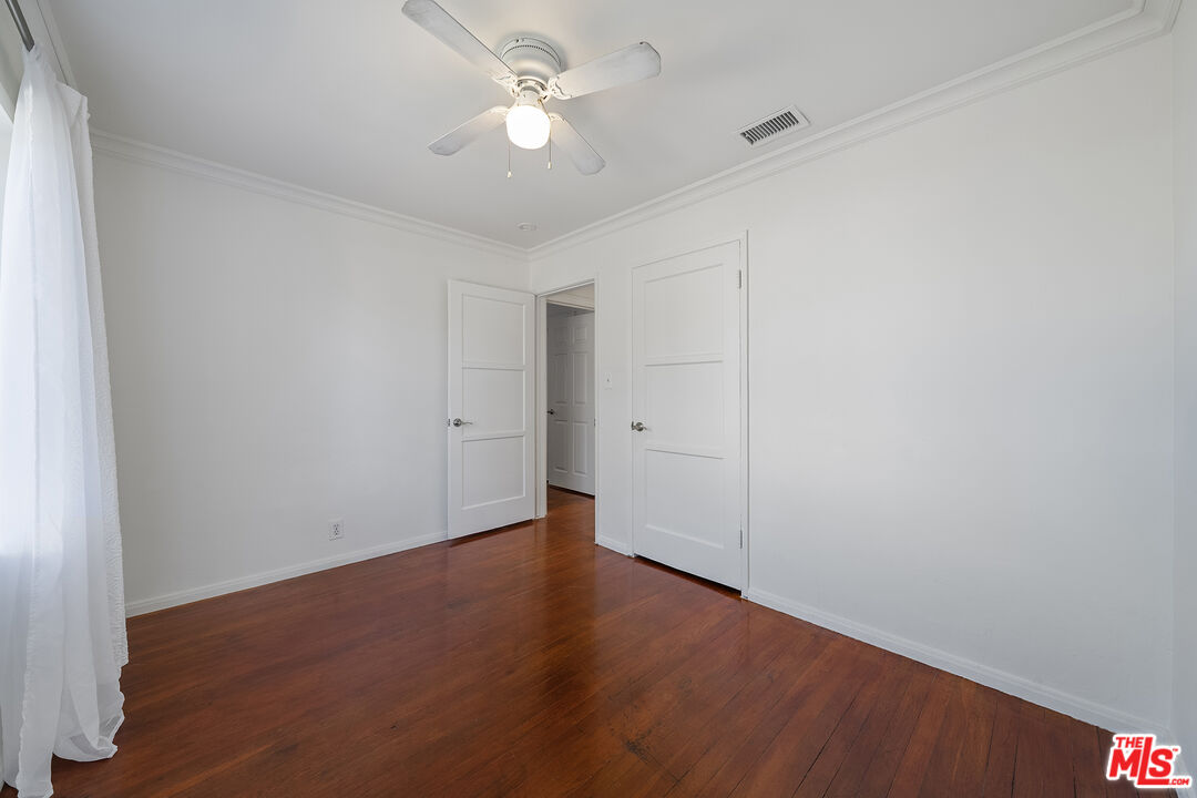 4516 Walnut Avenue Long Beach, CA 90807 - Photo 20 of 35 an empty room with wooden floor and ceiling fan