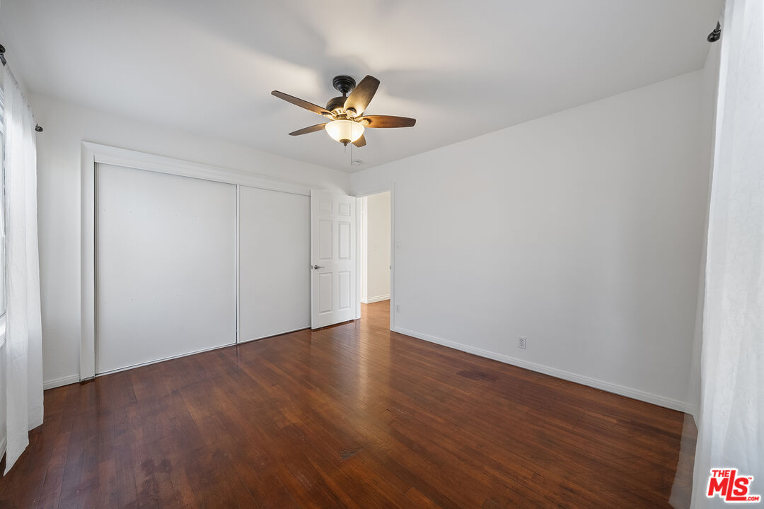 4516 Walnut Avenue Long Beach, CA 90807 - Photo 22 of 35 a view of an empty room with wooden floor and a ceiling fan