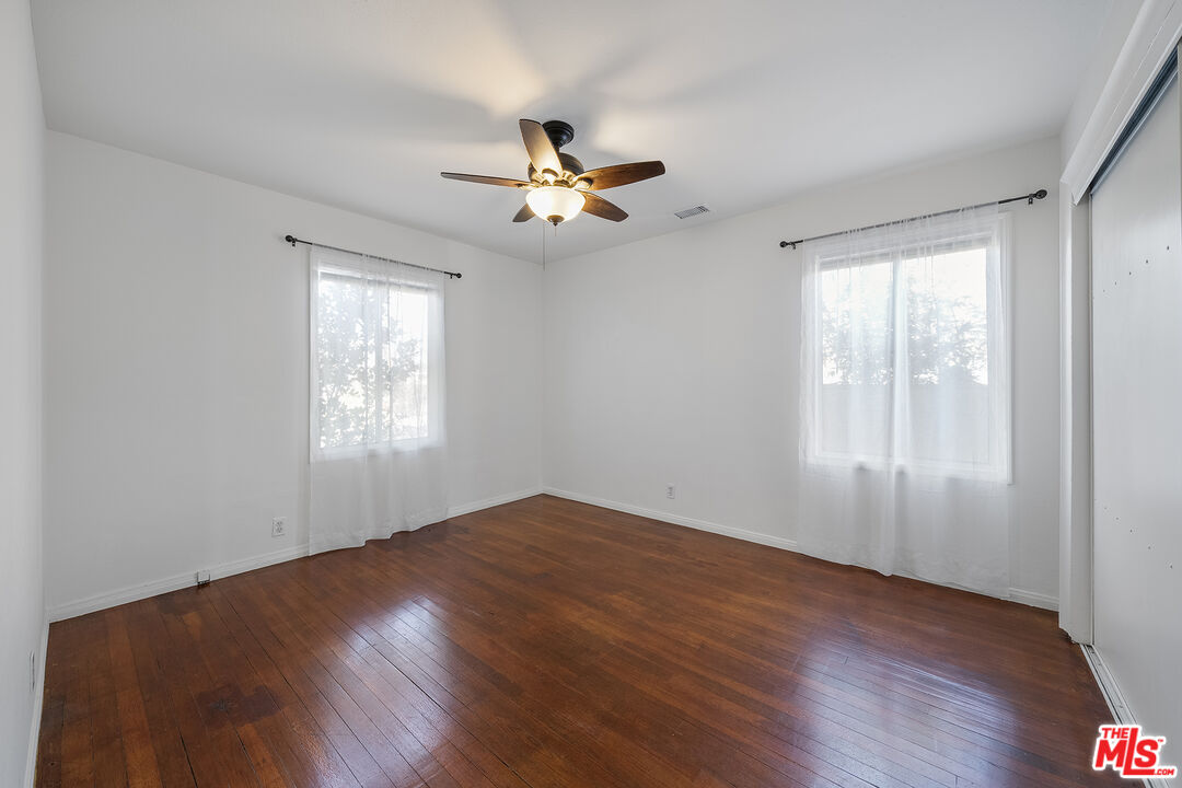 4516 Walnut Avenue Long Beach, CA 90807 - Photo 23 of 35 an empty room with wooden floor fan and windows