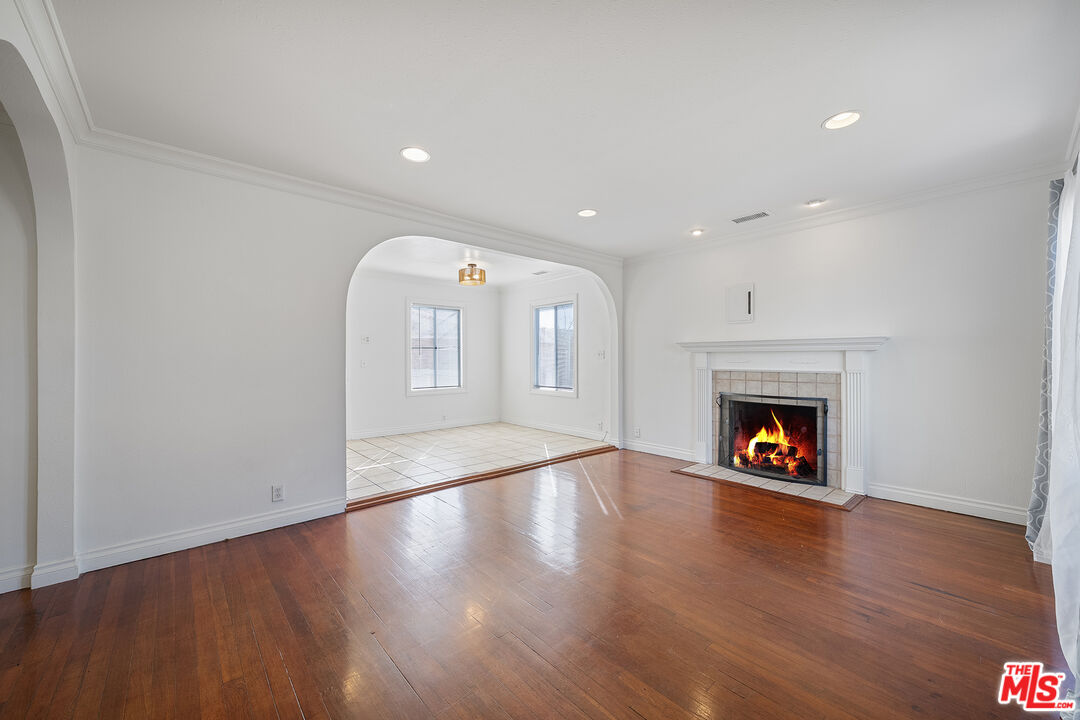 4516 Walnut Avenue Long Beach, CA 90807 - Photo 5 of 35 a view of an empty room with wooden floor and a fireplace
