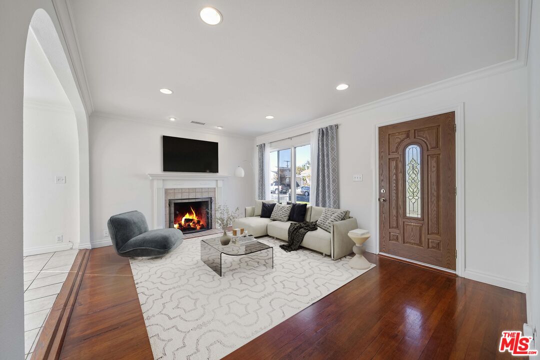 4516 Walnut Avenue Long Beach, CA 90807 - Photo 7 of 35 a living room with furniture a fireplace and a flat screen tv