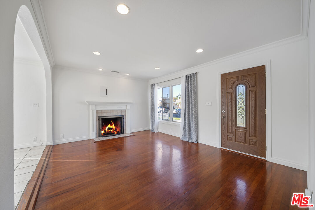 4516 Walnut Avenue Long Beach, CA 90807 - Photo 8 of 35 a view of a livingroom with wooden floor a fireplace and window