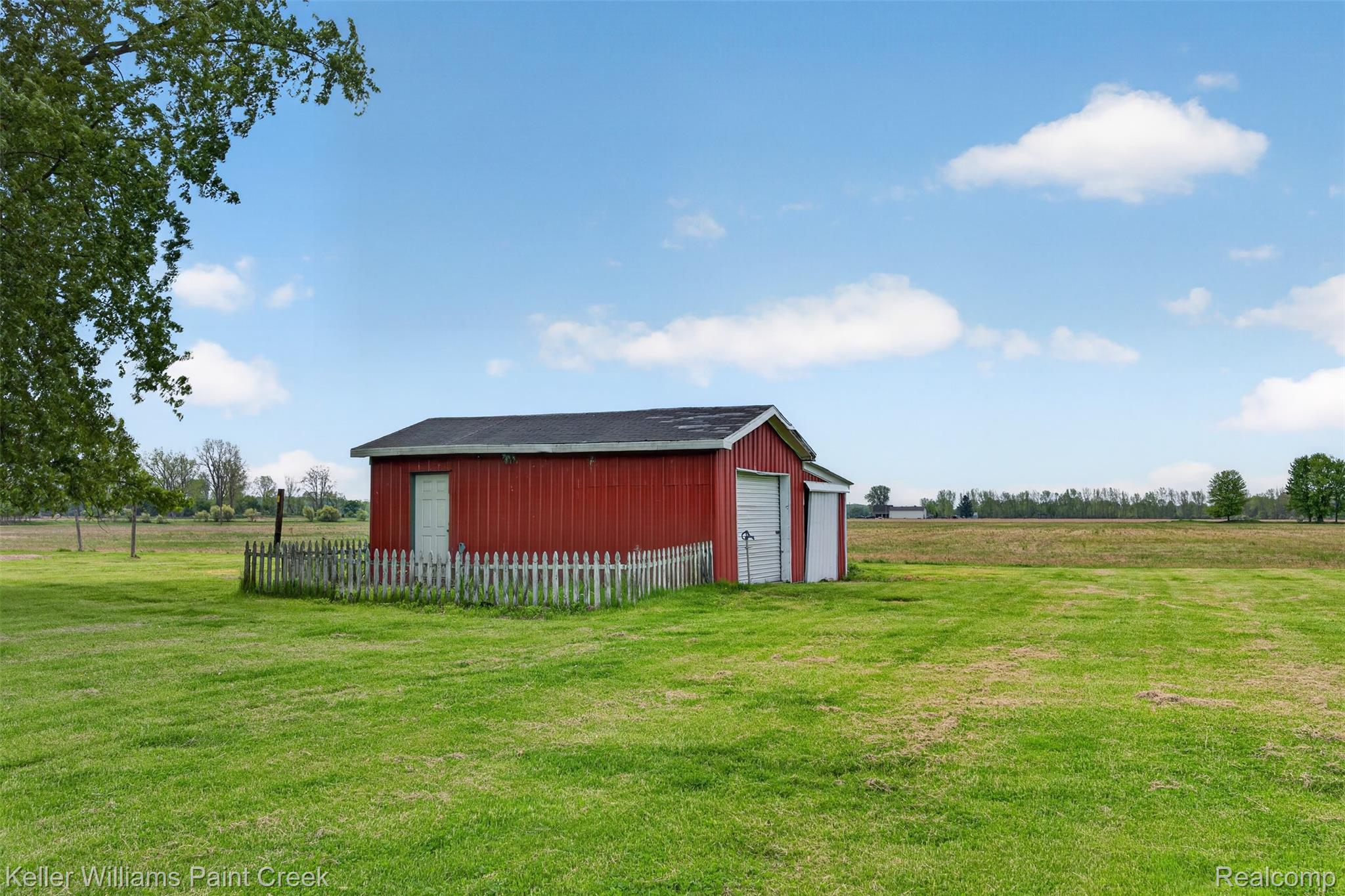18125 Nelson Road St. Charles, MI 48655 - Photo 44 of 63 View of yard featuring an outdoor structure, a garage, and a rural view