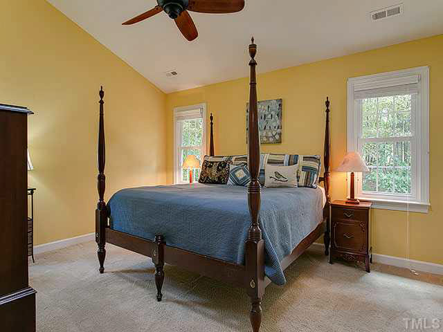 805 Bromley Way Raleigh, NC 27615 - Photo 11 of 25 a bedroom with a bed a dresser next to a window