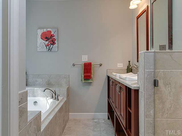805 Bromley Way Raleigh, NC 27615 - Photo 13 of 25 a bathroom with a tub sink and mirror