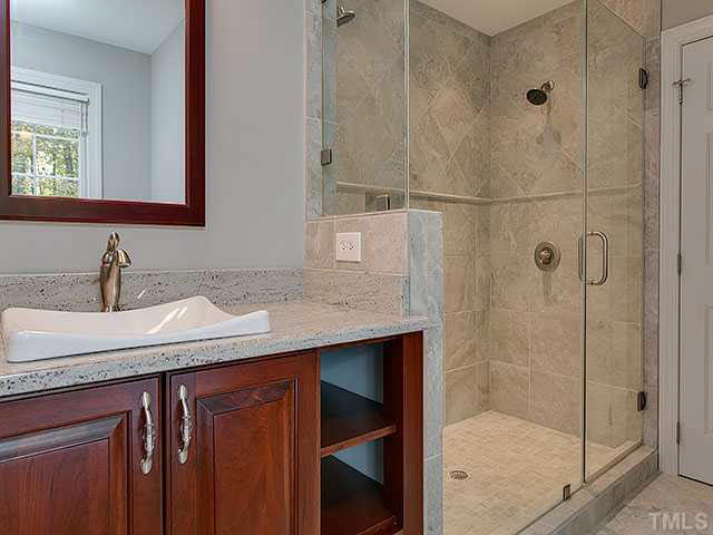 805 Bromley Way Raleigh, NC 27615 - Photo 14 of 25 a bathroom with a granite countertop sink a mirror and shower