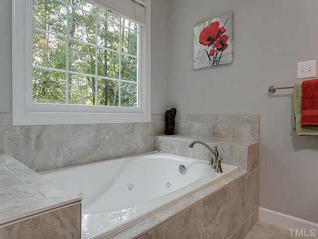 805 Bromley Way Raleigh, NC 27615 - Photo 15 of 25 a bathroom with a bathtub and a window
