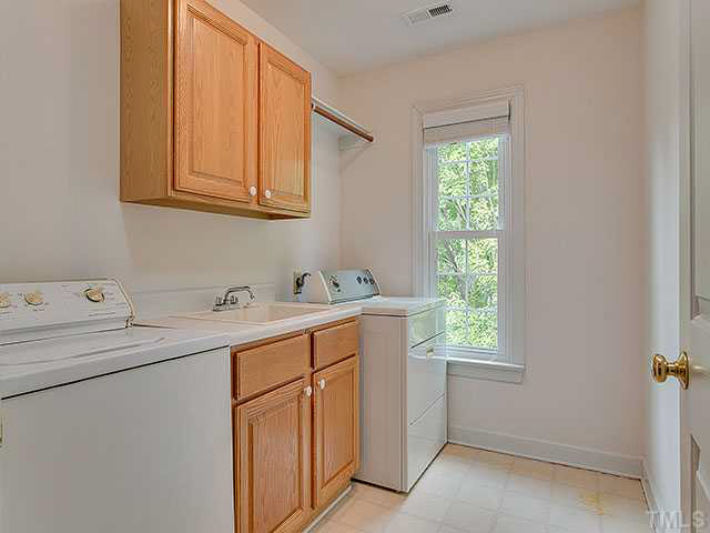 805 Bromley Way Raleigh, NC 27615 - Photo 22 of 25 a utility room with cabinets dryer and washer