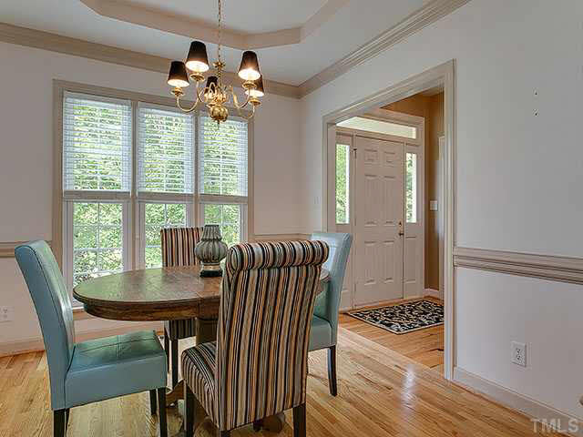 805 Bromley Way Raleigh, NC 27615 - Photo 5 of 25 a view of a dining room with furniture wooden floor and chandelier