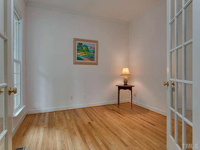 805 Bromley Way Raleigh, NC 27615 - Photo 6 of 25 a view of an empty room with wooden floor and a window