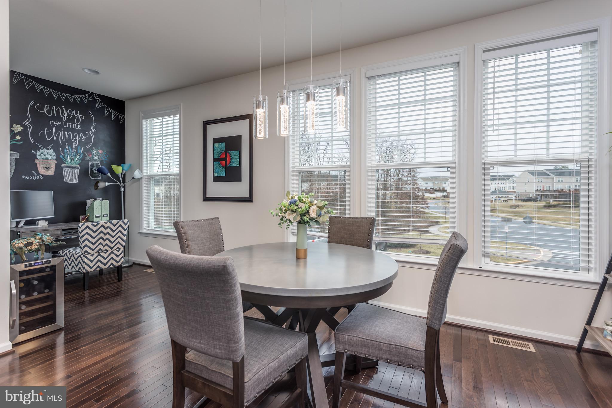 148 Solara Drive Winchester, VA 22602 - Photo 12 of 32 a view of a dining room with furniture window and wooden floor