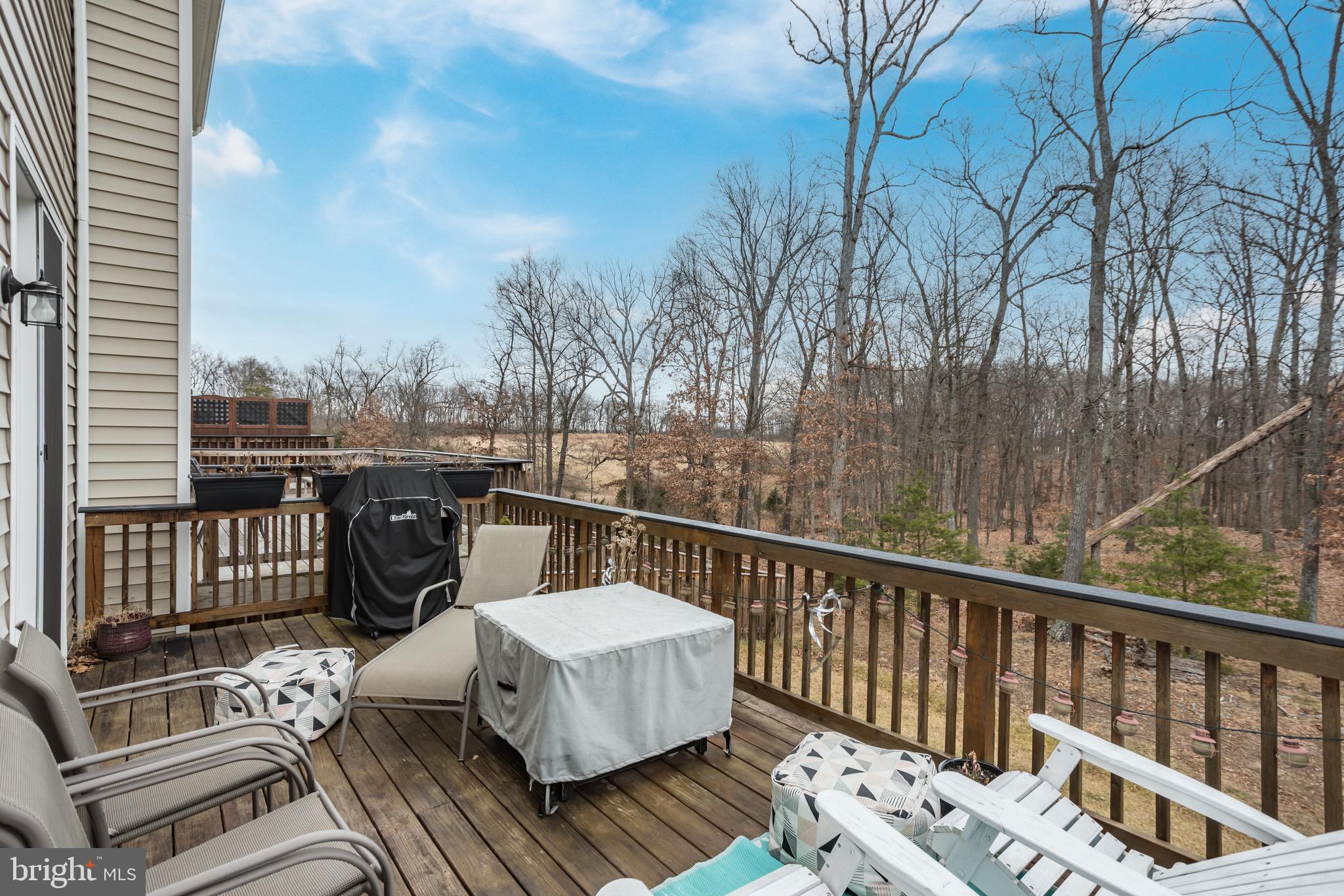 148 Solara Drive Winchester, VA 22602 - Photo 16 of 32 a view of a balcony with wooden floor and outdoor seating