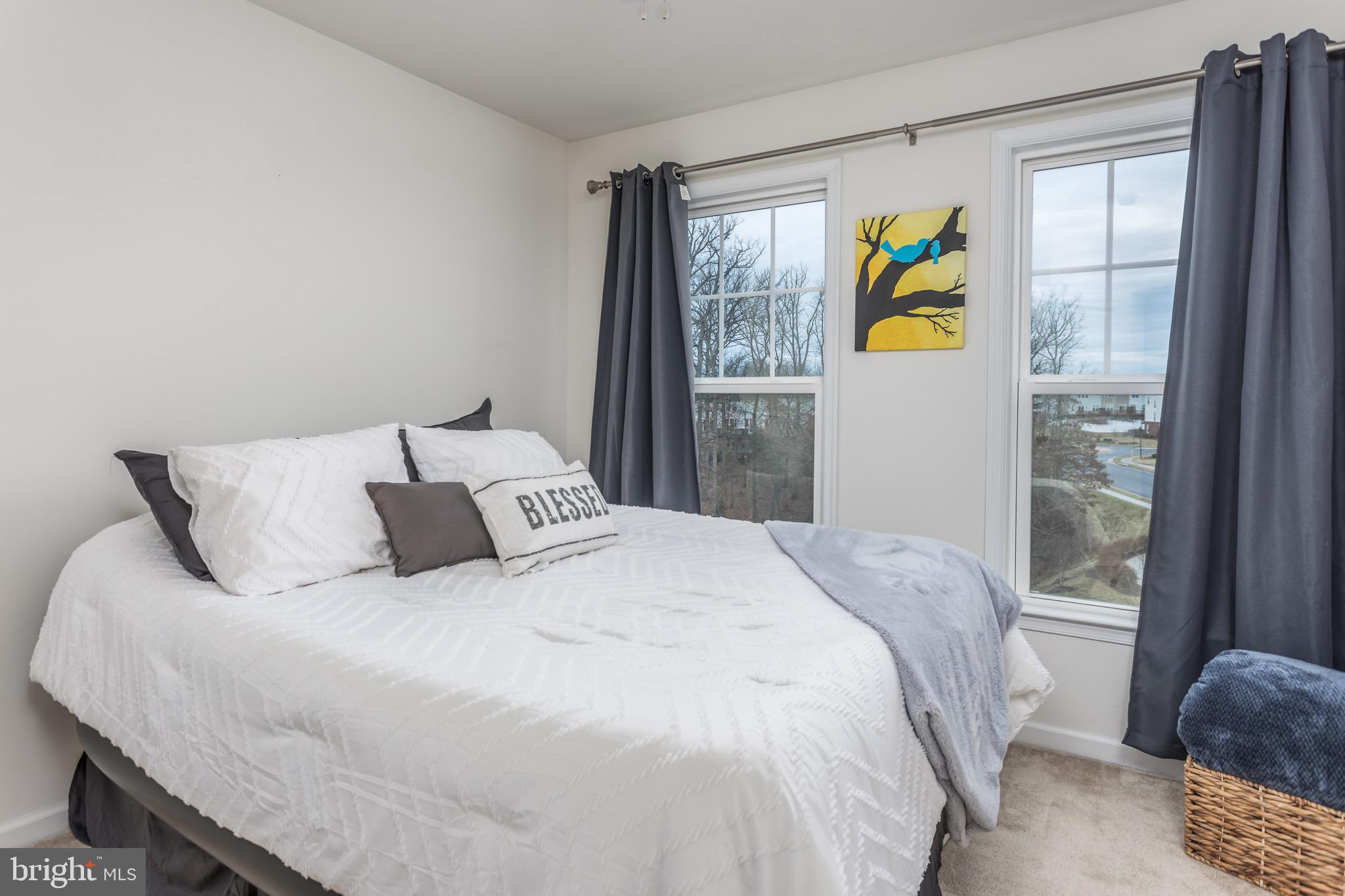 148 Solara Drive Winchester, VA 22602 - Photo 19 of 32 a bedroom with a bed window and mirror