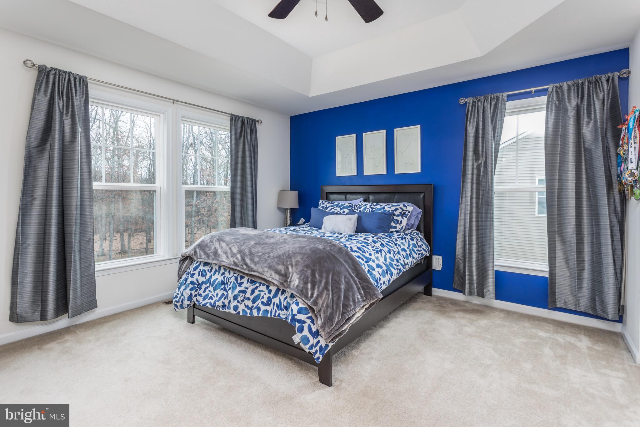 148 Solara Drive Winchester, VA 22602 - Photo 22 of 32 a bed sitting in a bedroom next to a window